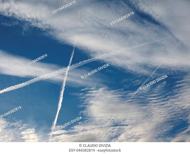 blue sky with plane vapour trails (aka contrails, short for condensation trails)