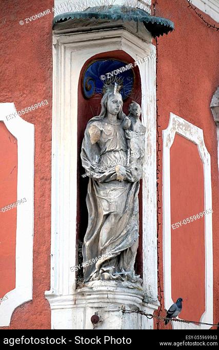Virgin Mary with baby Jesus, statue on the house facade in Ptuj, town on the Drava River banks, Lower Styria Region, Slovenia