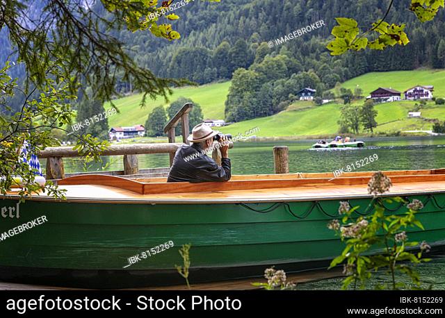Ferryman of the Annerl ferry station at Hintersee keeps an eye out for passengers, Ramsau bei Berchtesgaden, Bavaria, Germany, Europe