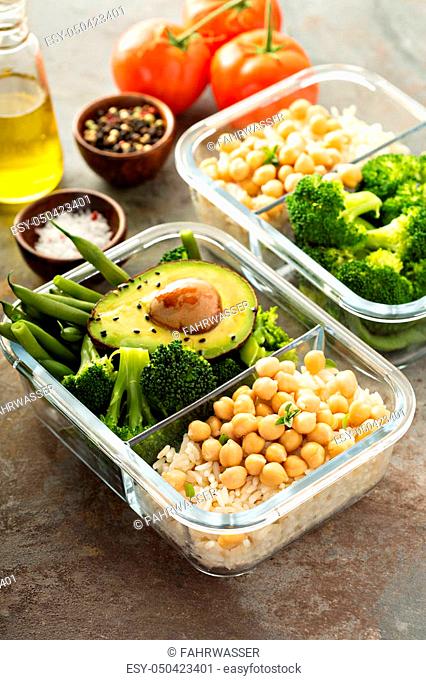 Vegan meal prep containers with cooked rice, chickpeas and vegetables
