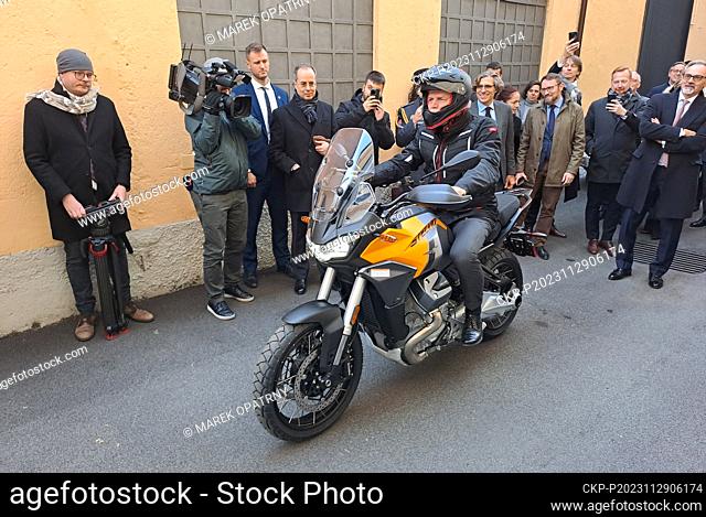 Czech President Petr Pavel rides a motorcycle during the visit of the Moto Guzzi factory and museum in the Italian region of Lombardy, on November 29, 2023