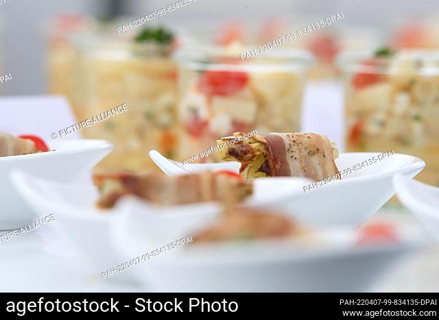 06 April 2022, Hessen, Weiterstadt: Asparagus wrapped in ham stands in a small bowl on a table. Photo: Sebastian Christoph Gollnow/dpa