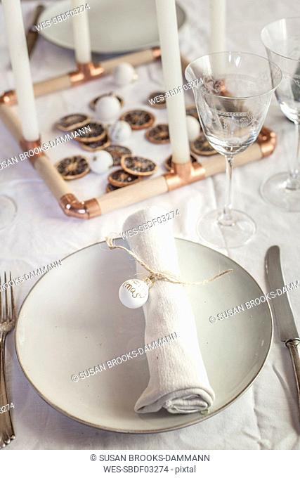 Place setting on laid table at Christmas time