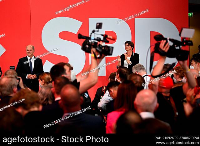 26 September 2021, Berlin: Olaf Scholz, Finance Minister and SPD candidate for Chancellor, stands with SPD party chairwoman Saskia Esken during the election...