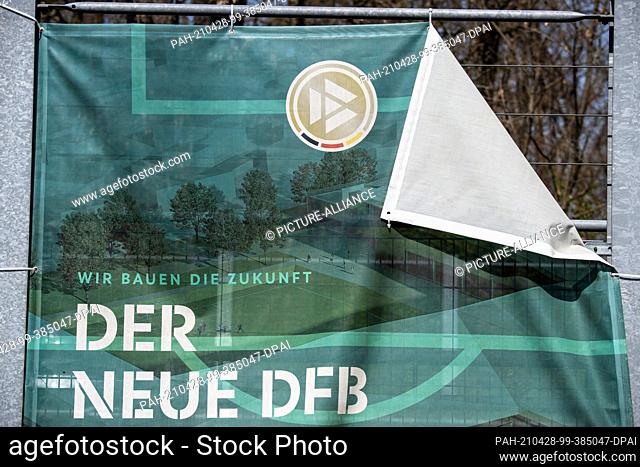 28 April 2021, Hessen, Frankfurt/Main: An old privacy screen with the inscription ""The new DFB"" hangs on a fence at the headquarters of the German Football...