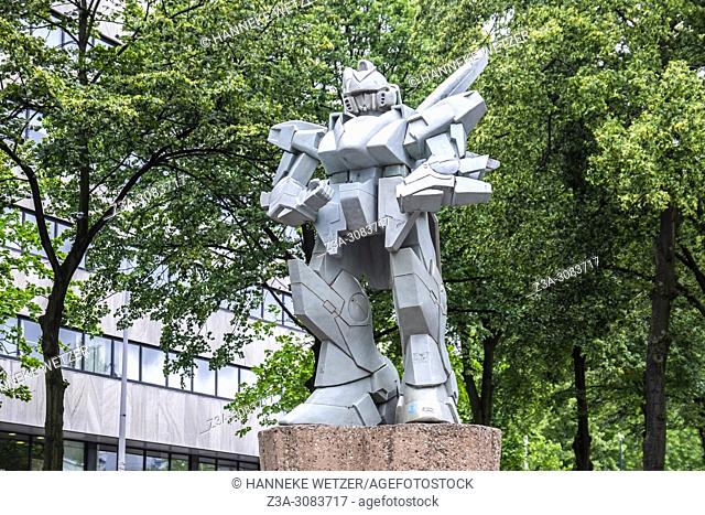 The Guard, a 3 meter high ceramic Gundam robot statue by Hans van Benthem placed on a piece of comet in Rotterdam, the Netherlands, Europe