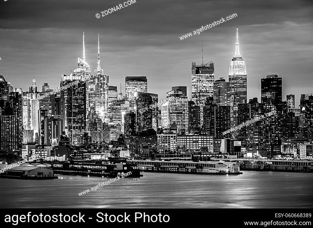 West New York City midtown Manhattan skyline panorama view from Boulevard East Old Glory Park over Hudson River at night. Black and white image
