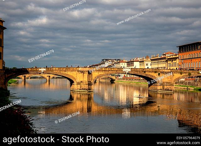 FLORENCE, TUSCANY/ITALY - OCTOBER 20 : View of buildings along and across the River Arno in Florence on October 20, 2019. Unidentified people