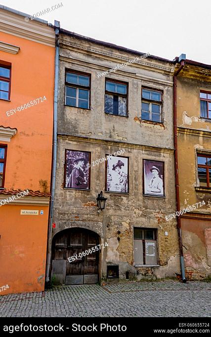 Lublin, Poland - 13 September, 2021: shabby old buildings in the historic city center of lublin with old photographs from the city's history