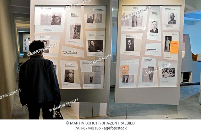 A woman looks at panels with individual cases in the new permanent exhibition 'Buchenwald. Ostracism and Violence 1937 to 1945' in Buchenwald near Weimar