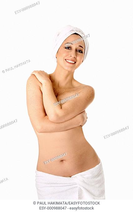 Portrait of a beautiful naked happy woman in towels with arms crossed covering breasts at spa bath shower, isolated