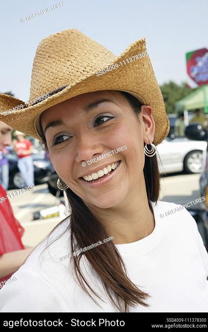 Portrait of Hispanic woman wearing cowboy hat