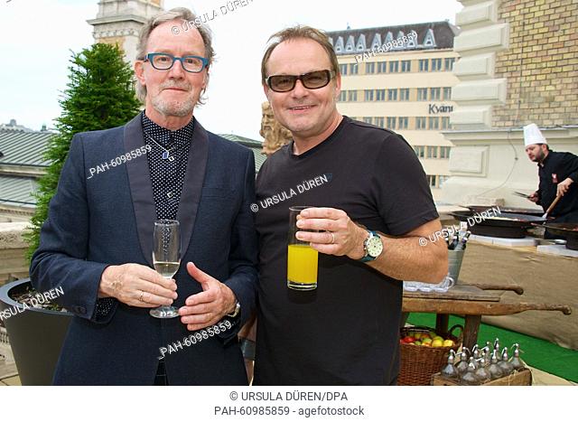 John Helliwell (L), co-founder of British rock band Supertramp and saxophonist, and British singer Nick van Eede pose at the reception prior to the open-air...