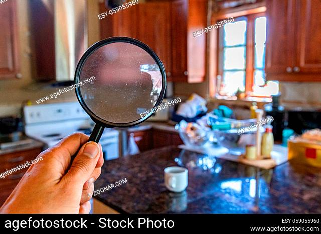 Searching inside the family kitchen using a magnifying glass in first person view FPV, during a home environmental quality survey with room for text