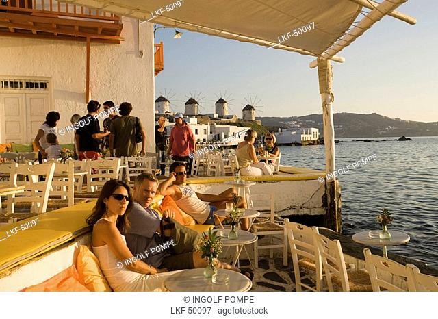 People sitting in restaurant directly at sea, Little Venice, Mykonos-Town, Mykonos, Greece