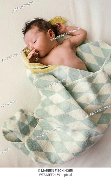 Newborn baby boy wrapped in blanket