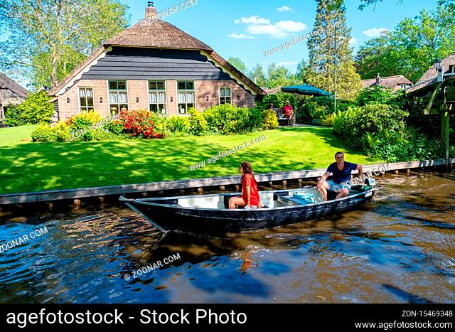 GIETHOORN, NETHERLANDS May 2020 view of typical houses of Giethoorn on May 2020 in Giethoorn, The Netherlands. The beautiful houses and gardening city is know...