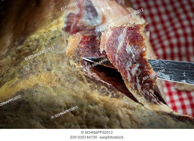 A pata negra spanish dried ham on a dark background
