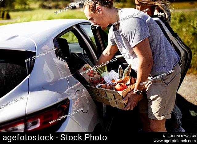 Man loading shopping into car