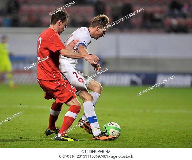 Czech Republic's Ladislav Krejci, right, fight for the ball with Canada's Nik Ledgerwood during their friendly soccer match in Oloumouc, Czech Republic, Friday