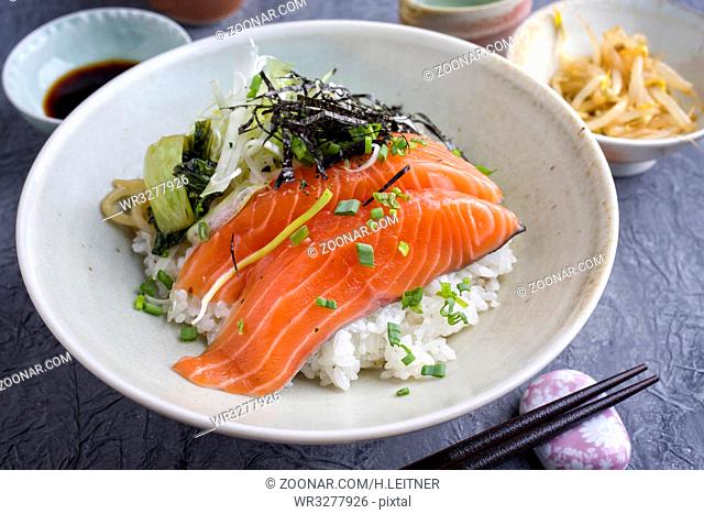 Traditional Japanese Hokkaidon Thinly sliced salmon Donburi as close-up in a bowl