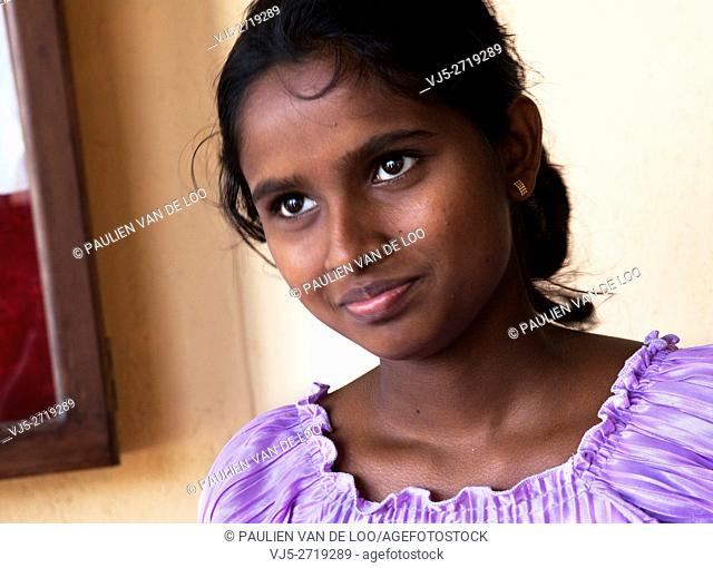 Sri Lanka, a young woman, she's a teacher of a local kindergarten, is smiling