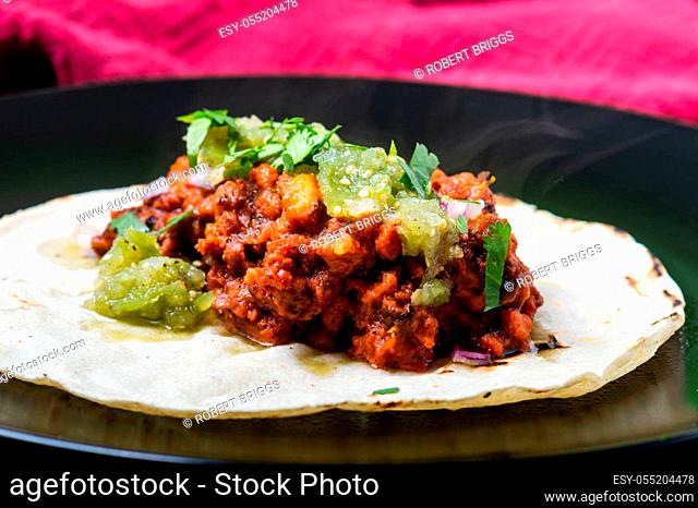 Vegetarian, vegan tacos al pastor with green salsa. Soya protein cooked with al pastor marinade and served on corn tortillas