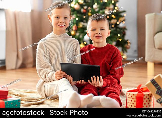 happy children with tablet pc on christmas at home