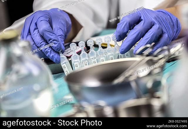 Nurse prepares medication in ampoules for oxygen mask in a hospital, conceptual image
