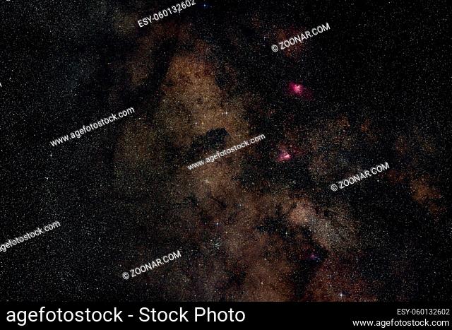 Night summer sky with milky way near Scutum constellation, bright Sagittarius clouds, purple Eagle and Swan nebula visible