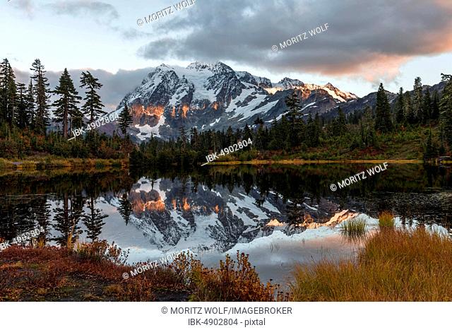 Sunset, Mt. Shuksan glacier with snow reflected in Picture Lake, wooded mountain landscape, Mt. Baker-Snoqualmie National Forest, Washington, USA