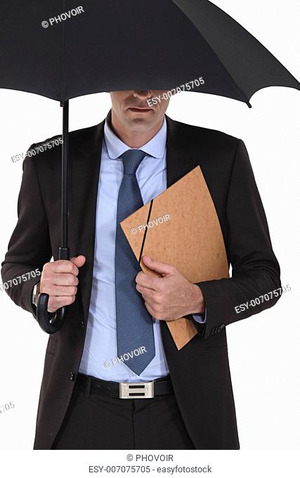 Businessman under an umbrella