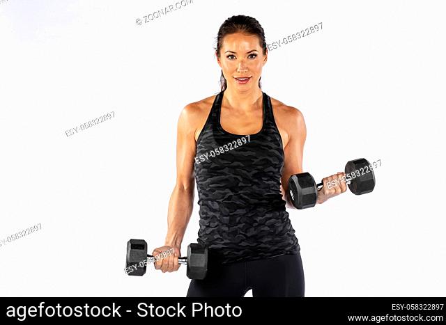 A gorgeous Brunette fitness model working out in a studio environment