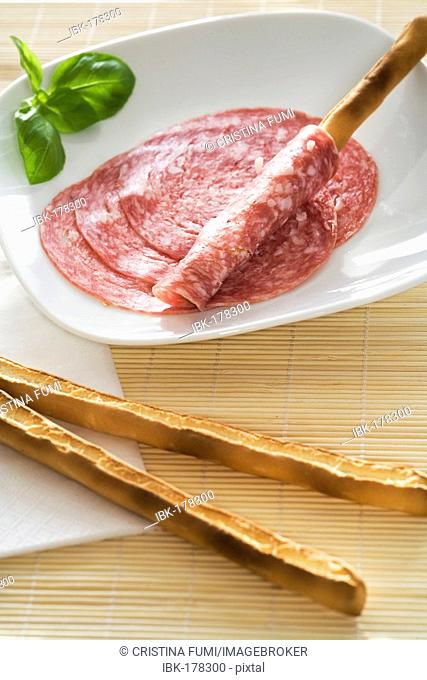 Breadsticks and salami slices
