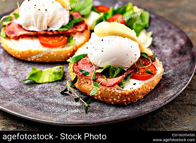 Delicious breakfast with eggs Benedict and salad