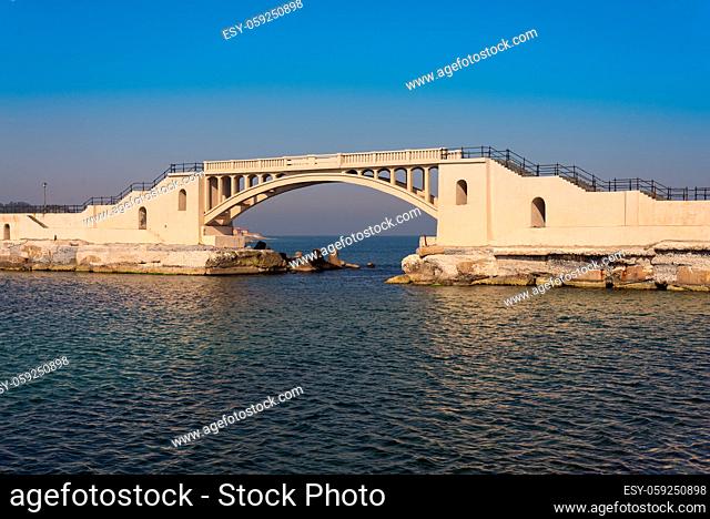 Bridge in the sea at Montazah park with calm sea and clear sky at sunrise time, Alexandria, Egypt