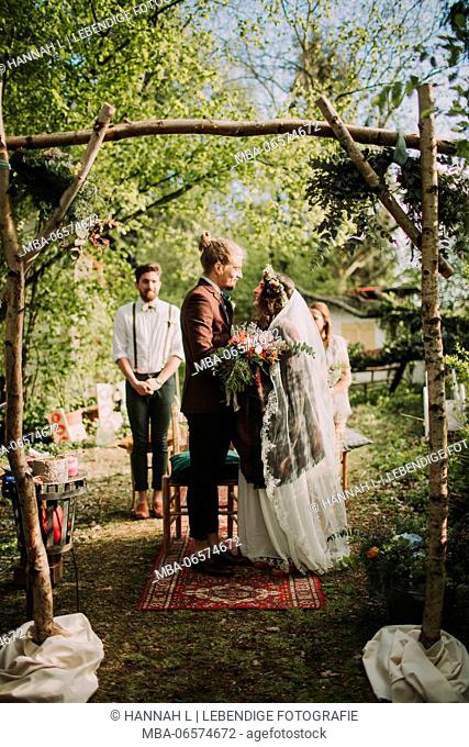 Alternate bridal couple at wedding ceremony outdoors