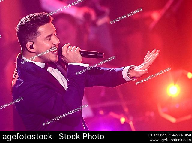 19 December 2021, Berlin: The singer Nico Santos is on stage at the final of the casting show ""The Voice of Germany 2021""