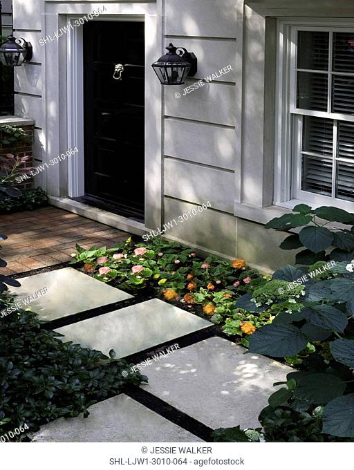 FRONT DOORS: City living, cut limestone, black door, brick walk, stepping stones, begonia and hydrangea