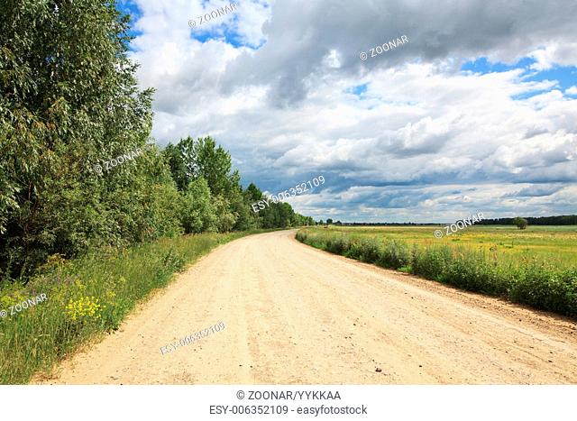 Cumulus clouds above the road in the steppe