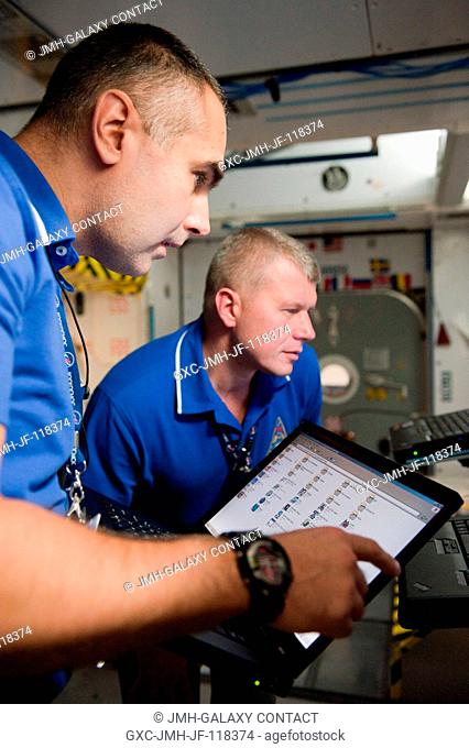 Russian cosmonauts Evgeny Tarelkin (foreground) and Oleg Novitskiy, both Expedition 3334 flight engineers, participate in a routine operations training session...