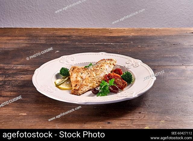 Pan-fried fish fillet with dried tomatoes and broccoli