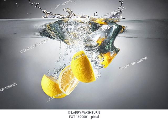 Close-up of lemon slices in splashing water