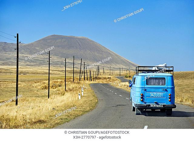 road to Sevan Lake through the Argitchi plateau, with Armaghan volcano in the background, Gegharkunik region, Armenia, Eurasia