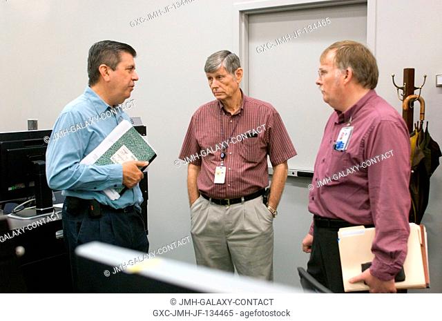 Alan R. (Rodney) Rocha (left), Division Chief Engineer; Dr. Don Curry, NASA Subsystem Expert; and Boeing engineer Darwin Moon discuss the R-Bar Pitch Maneuver...