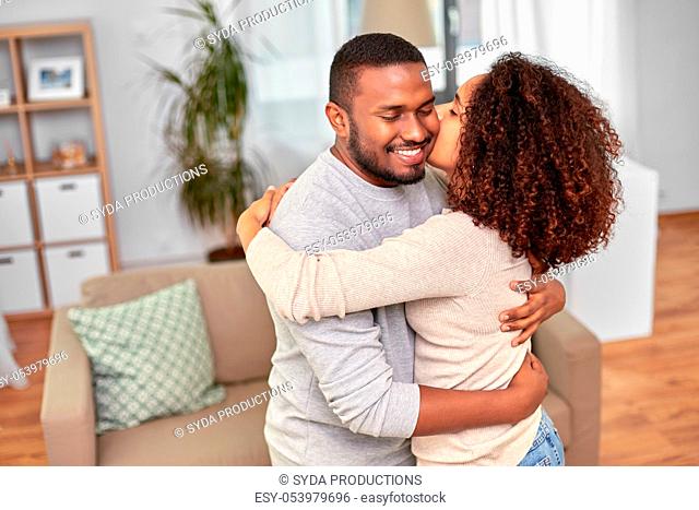 happy african american couple kissing at home