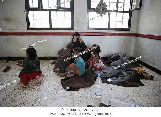 Displaced Yemenis, who fled their homes in the war-torn port city of Al Hudaydah, rest after arriving in Sanaa as clashes intensify in western coast areas