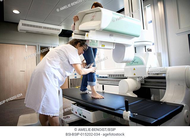 Reportage in a radiology centre in Haute-Savoie, France. A technician carries out a foot x-ray on a patient who had an operation on a hallux valgus