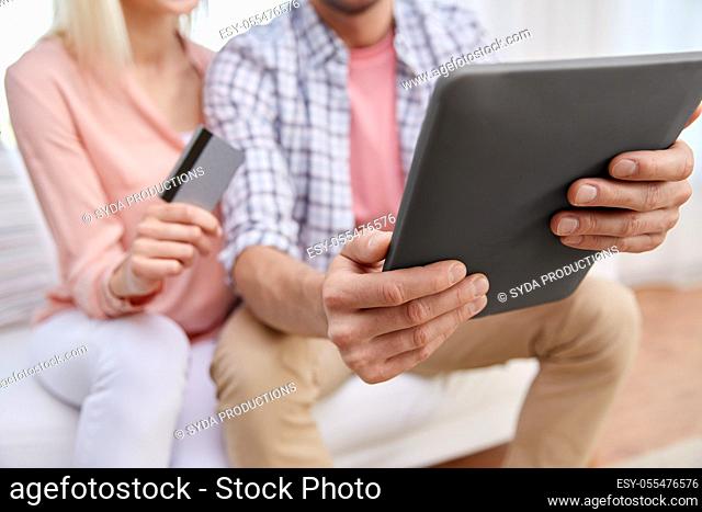 couple with tablet pc and credit card at home
