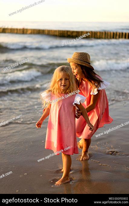 Happy siblings playing together at beach